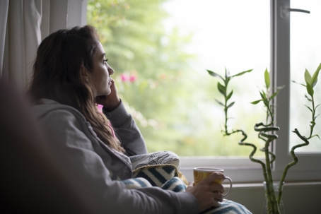 sad woman looking out the window